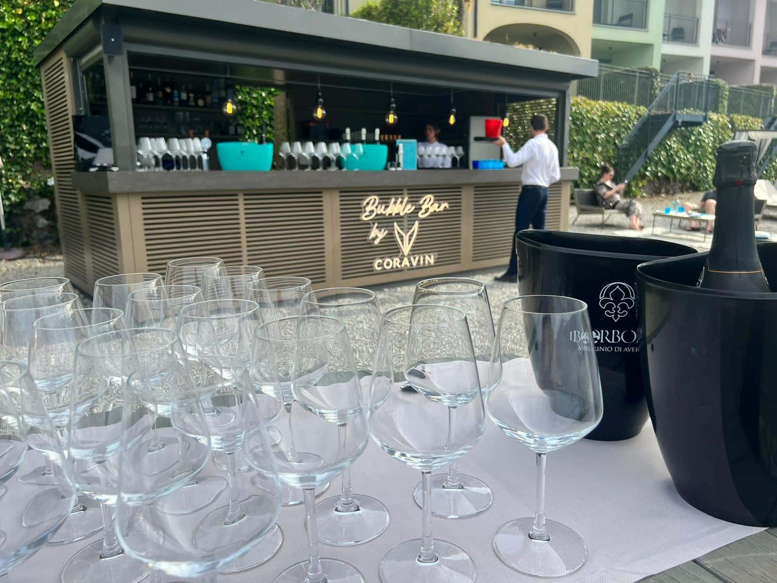 Outdoor Bubble Bar by Coravin setup with empty wine glasses and I Borboni sparkling wine in ice buckets.